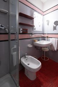 a bathroom with a sink and a toilet and a shower at Residence La Fenice in Padova