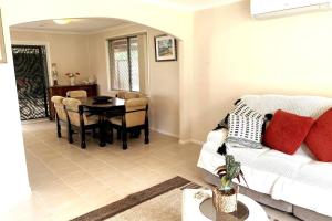 a living room with a couch and a table at Cheerful 3 bedrooms with free parking in Kingswood