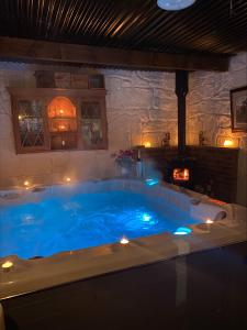 a hot tub in a room with lights in it at Nellie's Farmhouse in Carlingford