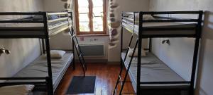 three bunk beds in a room with a window at La vita e bella in Saint-Jean-Pied-de-Port