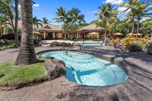 a swimming pool with a swing in front of a house at Ho'olei Garden View by Coldwell Banker Island Vacation in Wailea