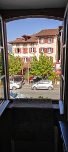 a view from a window of a street with a car at La vita e bella in Saint-Jean-Pied-de-Port