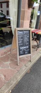 a chalkboard sign on the side of a street at La vita e bella in Saint-Jean-Pied-de-Port