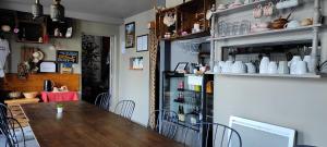 a dining room with a wooden table and chairs at La vita e bella in Saint-Jean-Pied-de-Port