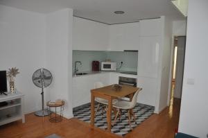 a kitchen with a table and chairs in a room at Koka's Apartment in Porto