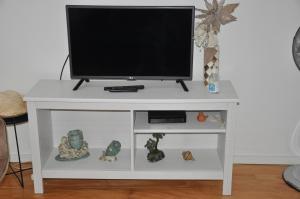 a white entertainment center with a television on top at Koka's Apartment in Porto