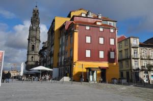 a group of buildings on a street with a clock tower at Koka's Apartment in Porto