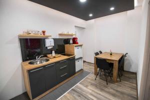 a small kitchen with a sink and a table at Villa Panorama in Sarajevo