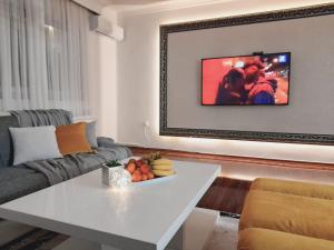 a living room with a white table and a couch at Apartman Jasmina in Bihać
