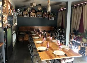 a long wooden table in a restaurant with candy canes on it at La vita e bella in Saint-Jean-Pied-de-Port +24 photos
