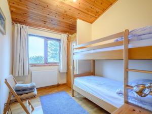 a bedroom with two bunk beds and a window at Ard Cuan in Torbeg