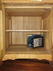 a wooden cabinet with a phone in it at Villa Tutilia in Willemstad
