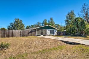 a house with a fence and a yard at Dog-Friendly Home, 10 Mi to Downtown Ocala in Ocala