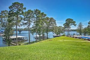 a golf course on the water with a dock at Quaint Condo with Views and Pool Access! in Hot Springs