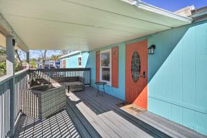 a blue house with a deck with a red door at Pet-Friendly Cocoa Home with Covered Porch! in Cocoa