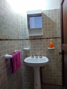 a bathroom with a sink and a mirror at Residencial ANAHATA in Capilla del Monte