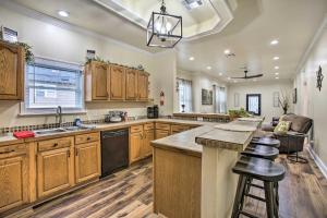 a large kitchen with wooden cabinets and a counter top at Central New Orleans Apt with Updated Interior in New Orleans