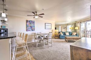 a kitchen and living room with a table and chairs at Oceanfront Condo, Walk to Pacific Beach! in San Diego