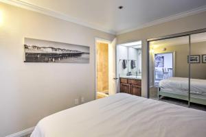 a bedroom with a bed and a bathroom at Oceanfront Condo, Walk to Pacific Beach! in San Diego