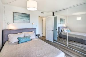 a bedroom with a bed and a mirror at San Clemente Condo with Gorgeous Views Near Beach! in San Clemente