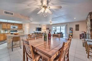 a dining room and kitchen with a table and a ceiling fan at Dog-Friendly Home with Pool in Lake Havasu City! in Lake Havasu City
