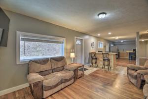 a living room with two couches and a kitchen at Mullens Cabin with Gas Grill and Mountain Views! in Mullens
