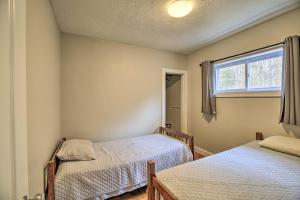 a bedroom with two beds and a window at Mullens Cabin with Gas Grill and Mountain Views! in Mullens