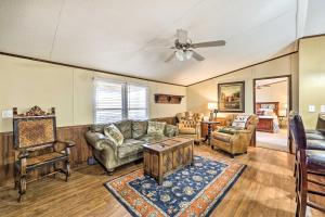 a living room with a couch and chairs and a ceiling fan at Ozark Mountain Cabin Rental on 300-Acre Ranch in Ozark