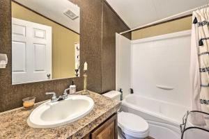 a bathroom with a sink and a tub and a toilet at Ozark Mountain Cabin Rental on 300-Acre Ranch in Ozark