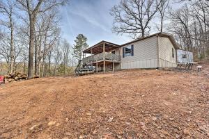 a house on top of a hill with trees at Ozark Mountain Cabin Rental on 300-Acre Ranch in Ozark