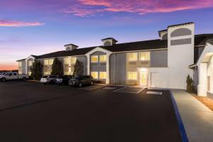 a large building with cars parked in a parking lot at Best Western Grants Inn in Grants