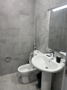 a bathroom with a white toilet and a sink at Fabulous 1BHK Jadaf Water Front Near Metro Station in Dubai