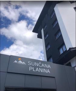 a sign in front of a building with a mountain at Diamond Kopaonik Centar in Kopaonik +9 photos