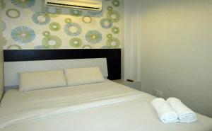 Postel nebo postele na pokoji v ubytování T-Hotel Bukit Bintang