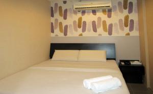 Postel nebo postele na pokoji v ubytování T-Hotel Bukit Bintang