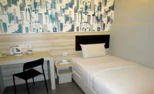 Postel nebo postele na pokoji v ubytování T-Hotel Bukit Bintang