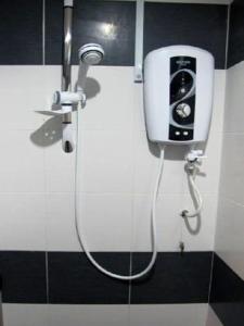 a shower in a bathroom with a soap dispenser at T-Hotel Bukit Bintang in Kuala Lumpur