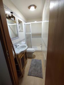 a bathroom with a sink and a toilet and a mirror at Segredos da Montanha by RetiroDoResende - Quarto Isolado in Seia