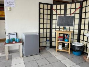 a room with a refrigerator and a chalkboard on a wall at Alojamiento de 2 Habitaciones con Baño Privado in Cusco