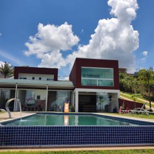uma casa com uma piscina em frente em SITIO EM IBIUNA CONDOMINIO RECREIO VERDE em Ibiúna