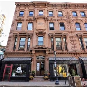 a large brick building with a store in front of it at New Haven Stays in New Haven