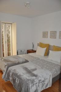 a bedroom with two beds and a window at Koka's Apartment in Porto