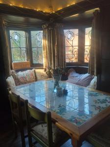 a dining room with a table and a couch at JESMOND House B&B room 4 in Hull