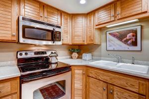 a kitchen with a stove microwave and a sink at PARK STATION 233 condo in Park City