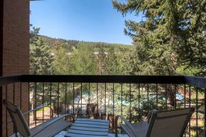 a balcony with two chairs and a view of a mountain at PARK STATION 233 condo in Park City