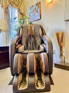 a brown leather reclining chair in a living room at Jessicahouse ltd. in Richmond