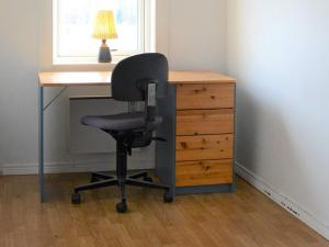 a desk with a chair next to a dresser at 3 person holiday home in HAMMARÖ-By Traum in Hammarö