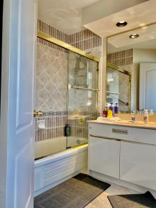 a bathroom with a shower and a sink and a tub at Jessicahouse ltd. in Richmond