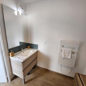 a bathroom with a sink and a large mirror at Héol in Saint Malo +8 photos