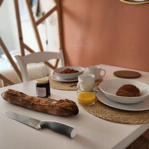 a table with a breakfast of bread and eggs on it at Héol in Saint Malo